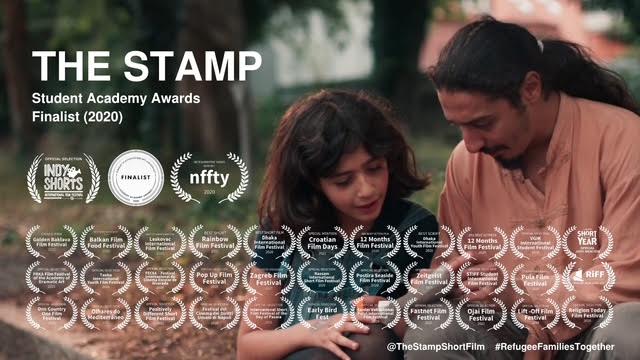 A man and a child sit close together outdoors, looking down at something in the child's hands. Numerous film festival laurels and text about “The Stamp” short film overlay the image.