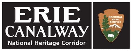 Sign for the Erie Canalway National Heritage Corridor with the National Park Service logo featuring trees, a mountain, and a bison.
